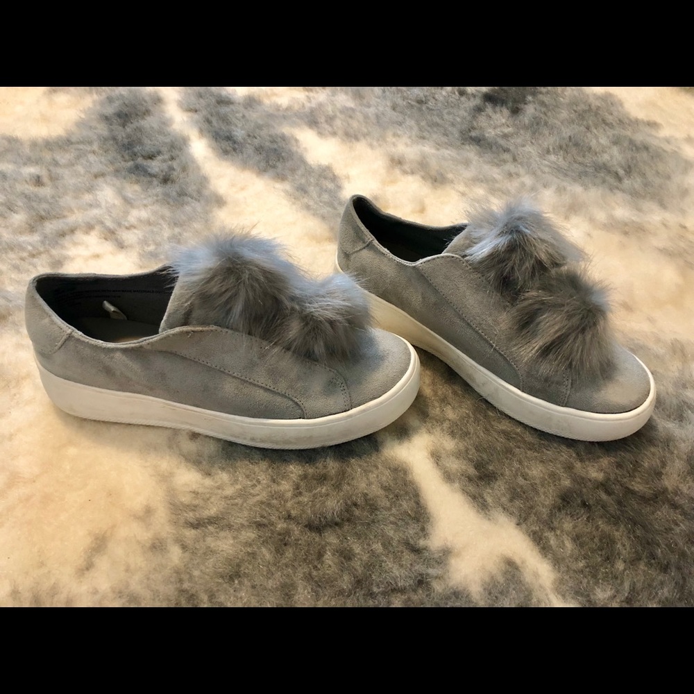 Grey suede slip-ons with faux fur pom-poms
